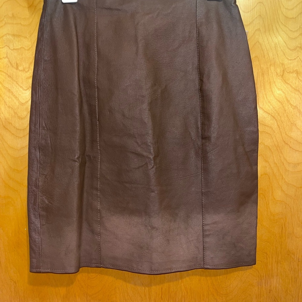 Brown leather skirt has leather variations. See photos